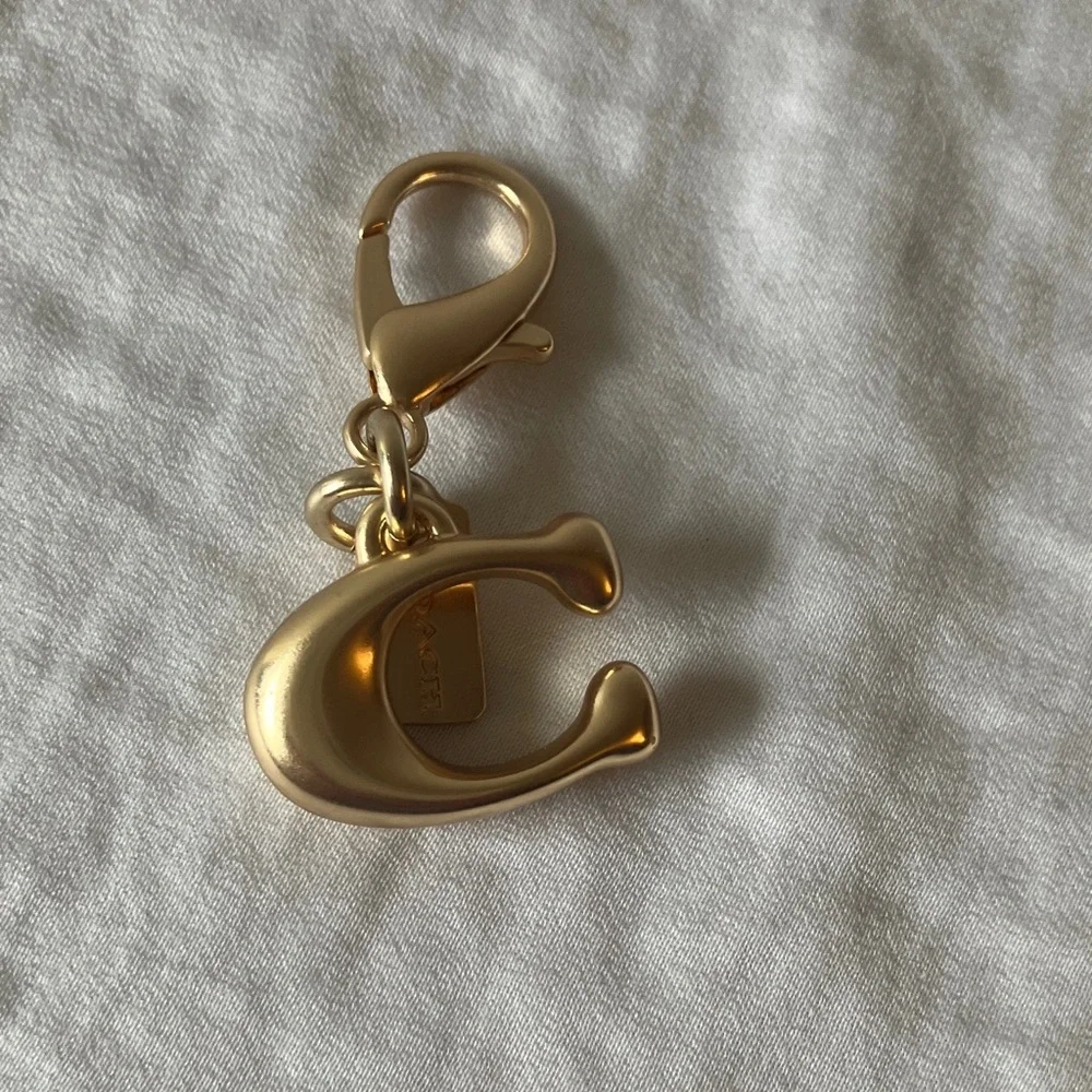 Coach: Metallic Gold Tone Key Holder Charm